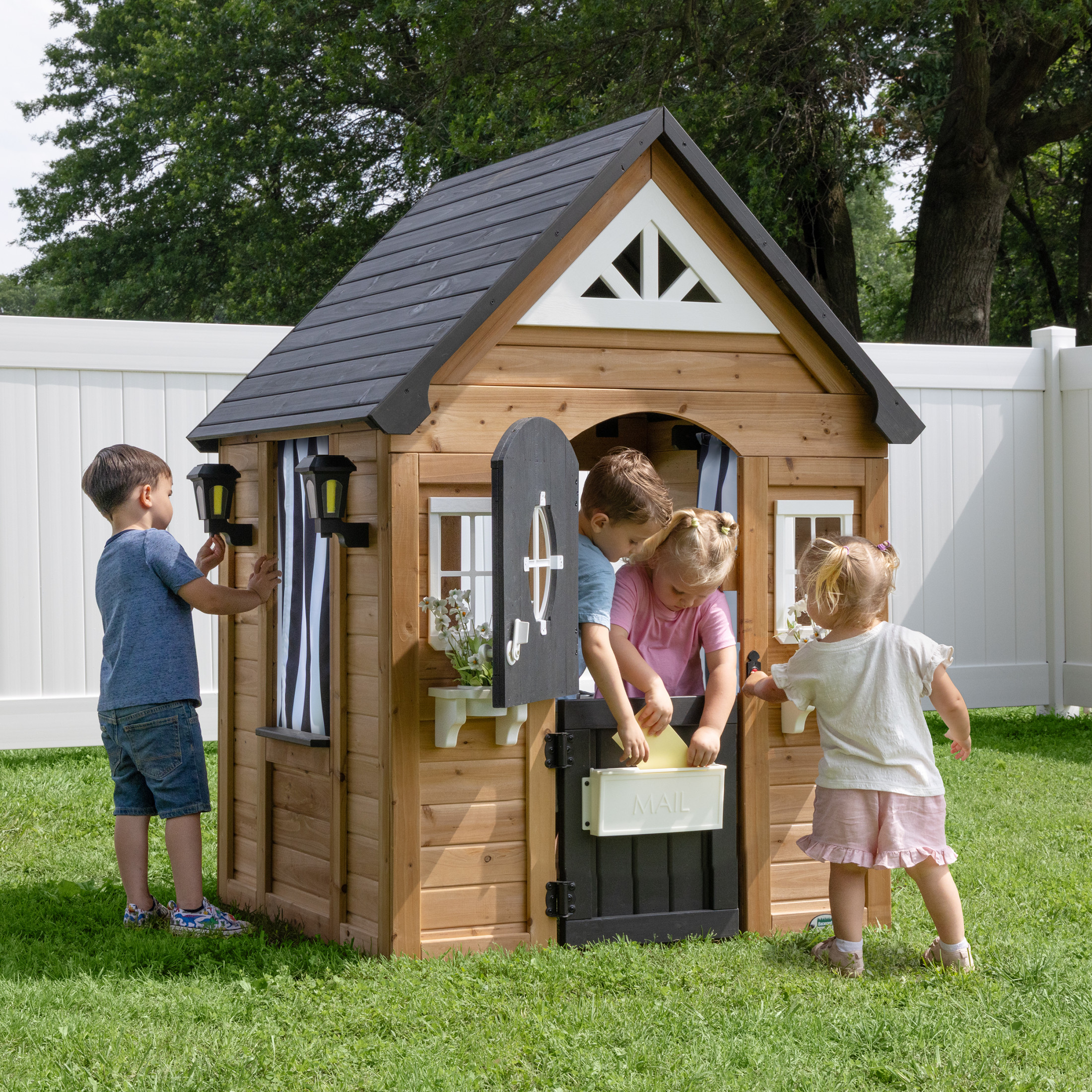 Backyard Discovery Mystic cedar playhouse with children playing